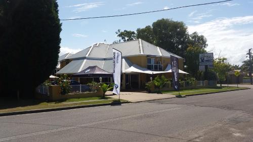 a building on the side of a street with a building at Admiral Nelson Motor Inn in Nelson Bay