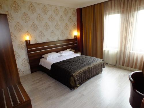 a hotel room with a bed and a window at Lifos Hotel in Kayseri