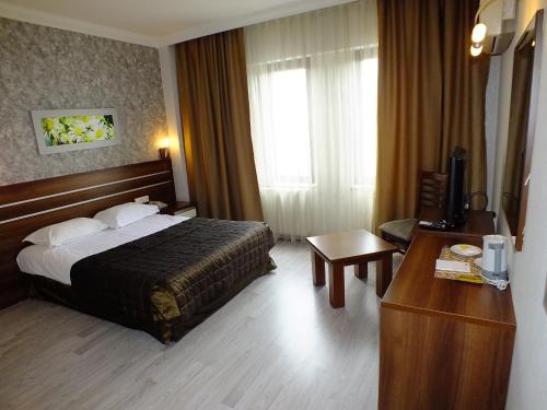 a hotel room with a bed and a desk at Lifos Hotel in Kayseri