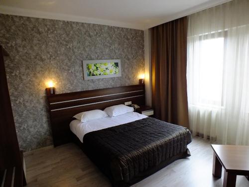 a hotel room with a bed and a window at Lifos Hotel in Kayseri