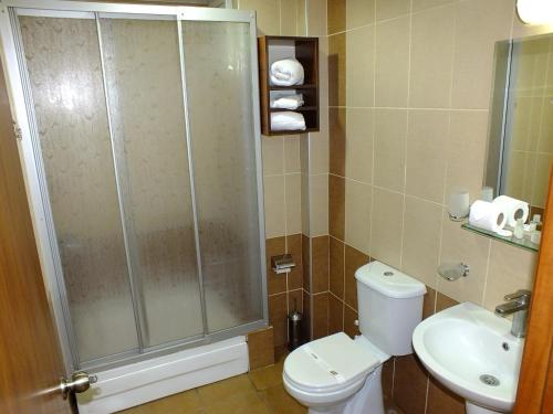 a bathroom with a shower and a toilet and a sink at Lifos Hotel in Kayseri