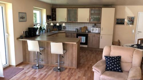 cocina con encimera y sillas en una habitación en Ferienwohnung Moin, en Kiel