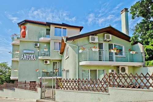 an apartment building with balconies and a fence at Hotel Amfora in St. St. Constantine and Helena