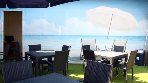 a table and chairs with a view of the ocean at Pension Village in Karlovy Vary