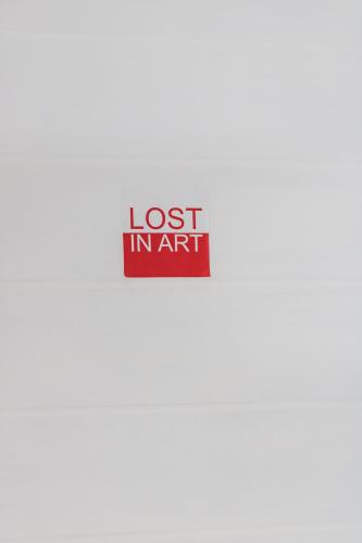 a sign that says lost in art on a wall at Agulhas Ocean House in Agulhas