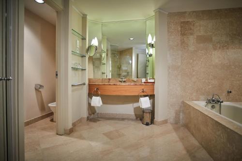 a bathroom with a tub and a toilet and a sink at Hyatt Regency Belgrade in Belgrade