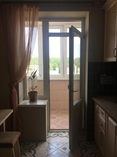 an open door to a bathroom with a window at Vyshyvanka in the city centre in Ivano-Frankivsk