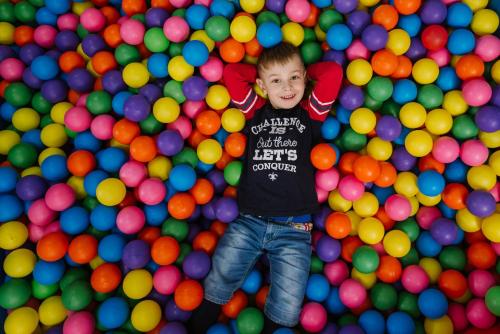 a young boy standing in a pile of balls at Lisova Pisnia Resort Hotel in Truskavets
