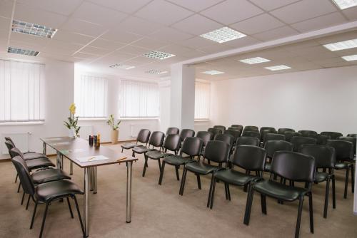 an empty room with chairs and tables in it at Lisova Pisnia Resort Hotel in Truskavets