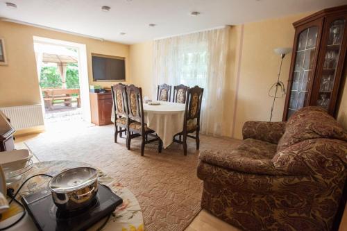 a living room with a couch and a table at Žvejo namas in Nida