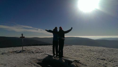 a man and woman standing on top of a mountain at Apartmajsko naselje Ribniško Pohorje in Ribnica na Pohorju