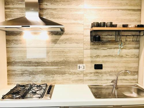 a kitchen with a sink and a stove at Sanremo Home Loft in Sanremo