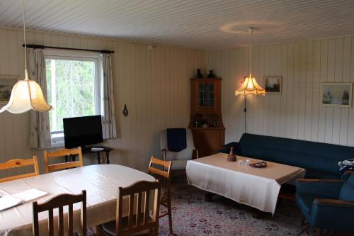 BirkelandにあるBergheim Two-Bedroom Cottageのリビングルーム(ベッド2台、ソファ、テーブル付)
