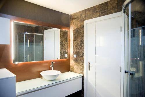 a bathroom with a sink and a mirror at Pine City Residence in Kusadası