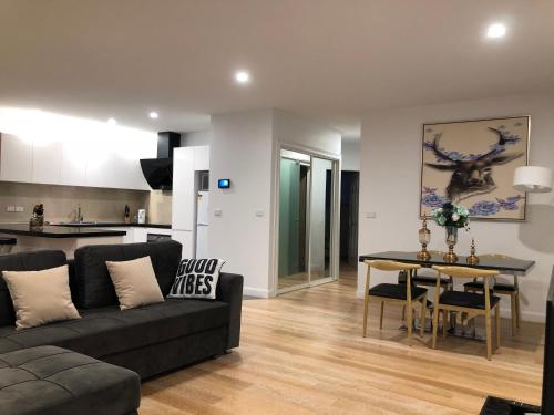 a living room with a couch and a table at Apartments in Phillip Island Towers - Block C in Cowes