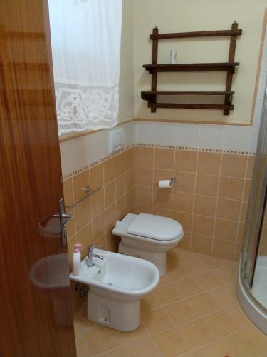 a bathroom with a toilet and a sink at "Da Alma" Centro Storico in Fano