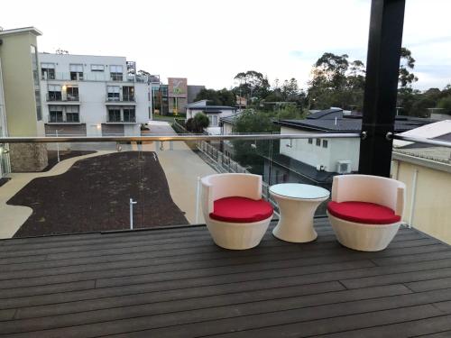 three chairs sitting on a balcony with a view at Apartments in Phillip Island Towers - Block C in Cowes