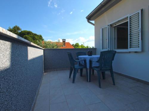 a patio with a table and chairs on a balcony at Apartment 1215 in Premantura