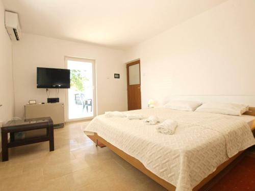 a bedroom with a large bed with towels on it at Apartment 1215 in Premantura