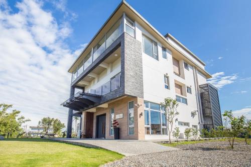 a large white building with glass windows at WMS Villa in Dongshan