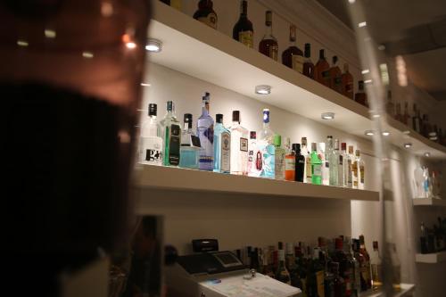 a shelf filled with bottles of alcohol on a wall at Hotel Jávea in Jávea