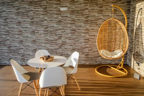 a table and chairs in a room with a brick wall at Quinta da Corujeira in Vila Real