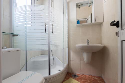 a bathroom with a shower and a toilet and a sink at Villa Jadranka Sutomore in Sutomore