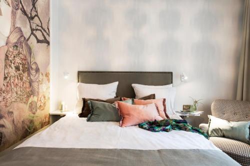 a bedroom with a large bed with many pillows at Best Western Kom Hotel Stockholm in Stockholm