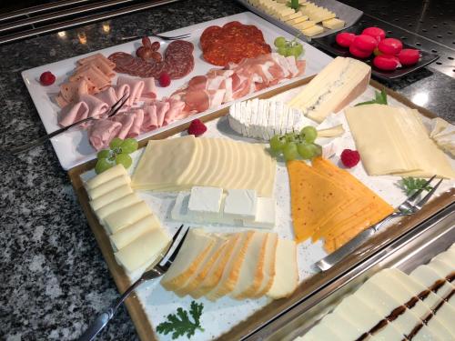 a display case with cheese and meats and fruit at Hotel Blüchertal in Bacharach