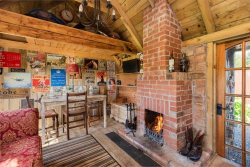 a living room with a brick fireplace and a table at The Love Shack nr Elie & St Andrews in Ceres