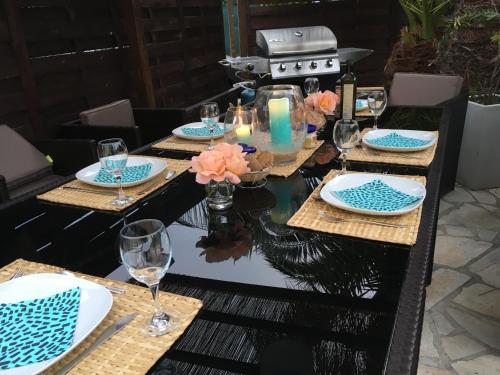 a table set for a dinner party with blue and white plates at Bed,Kitchen and Swimming Pool Villa Esterel in Saint-Raphaël