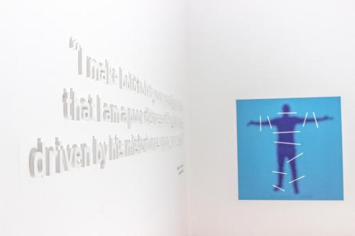 a book with a picture of a man on skis on a wall at Hotel Bela Fisterra in Finisterre