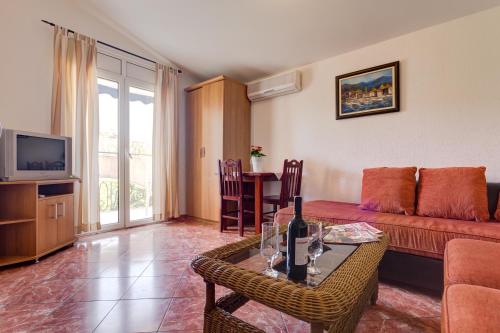 a living room with a couch and a table at Villa Jadranka Sutomore in Sutomore