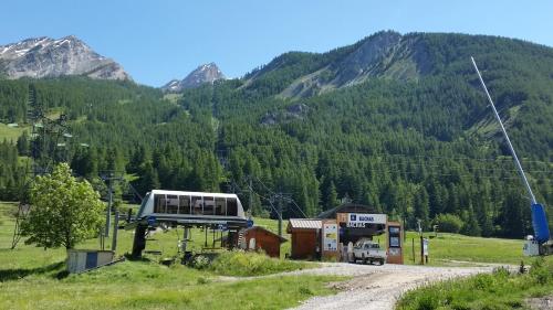 a bus parked at a gas station in the mountains at Les Sept Étoiles in Le Monêtier-les-Bains