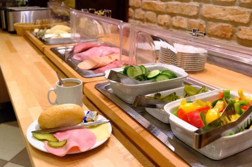 a buffet line with different types of food on it at Euro Youth Hotel Munich in Munich
