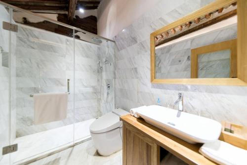 a bathroom with a toilet and a sink and a shower at Dali Old Courtyard Boutique Inn in Dali