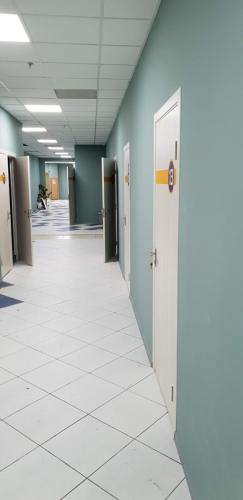 an empty hallway of an office building with doors at Hostel City Center in Chişinău