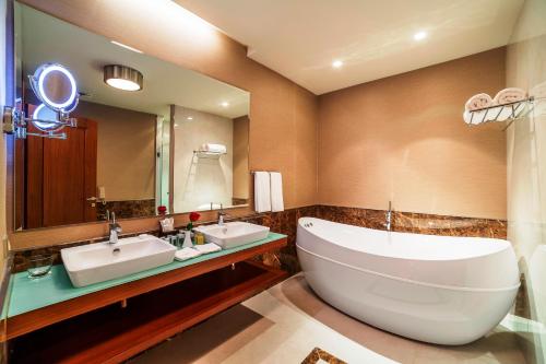 a bathroom with two sinks and a large mirror at Borjomi Likani Health & Spa Centre in Borjomi