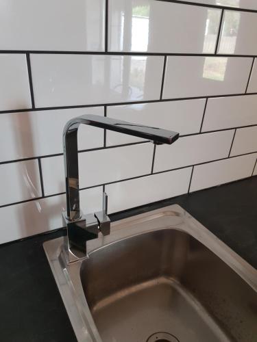 a kitchen sink with a faucet above it at Myers CBD in Bendigo