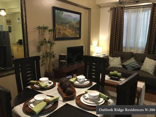 a living room with a table and a couch at Outlook Ridge Residences - North in Baguio