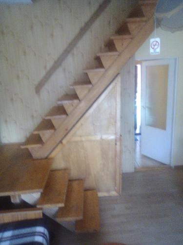 an empty room with a wooden staircase in a building at Ośrodek Wczasowy "GRONOSTAJ" in Rajcza