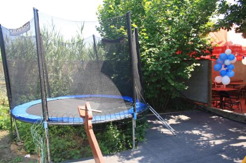 a trampoline with a net in a backyard at FKoka in Berehove