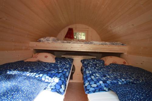 a room with two beds in a tiny house at Camping Du Parc in Pré-Saint-Didier