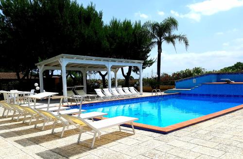 a swimming pool with lounge chairs and a gazebo at Hotel Villa Elisabetta in Galatina