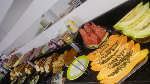 a buffet with a bunch of different types of food at Conforto Plaza Hotel in Capitão Leônidas Marques