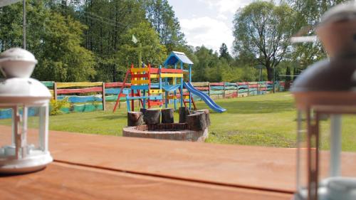 a park with a playground with a slide at Siedlisko Kępina Zdrój in Ostrów
