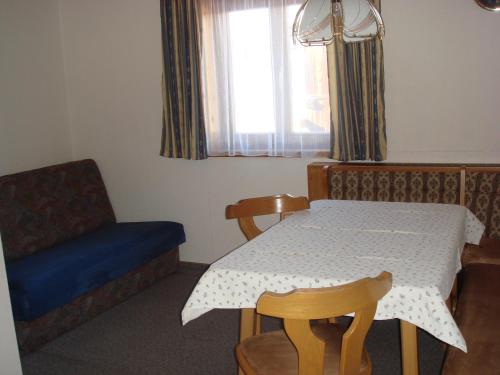 a room with a table and a chair and a window at Brandstättgut in Altenmarkt im Pongau
