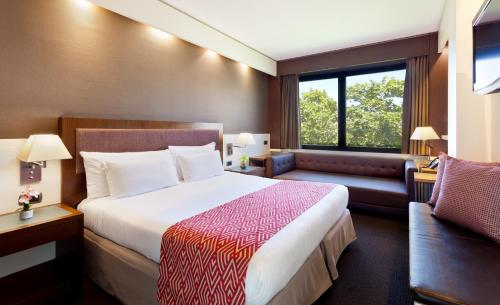 a hotel room with a bed and a couch at Royal Ramblas in Barcelona