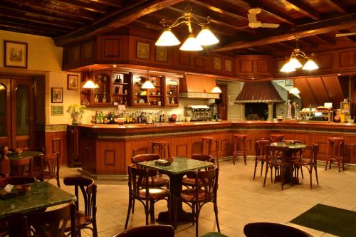 Un restaurante con mesas y sillas y un bar. en Hostal-Restaurante Paris, en Forcarei