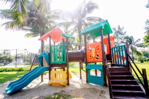 a playground with a slide in a park at Sunshine Apartment in 5* resort in Da Nang
